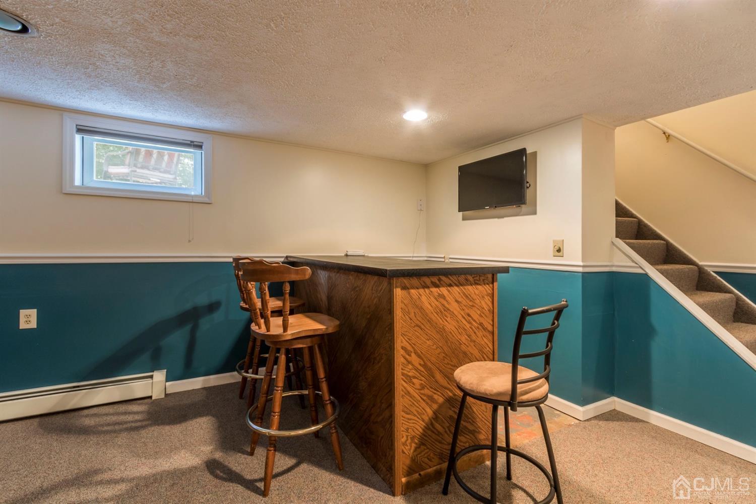 27 Mill Road Edison, NJ 08817 - Photo 23 of 31 a room with furniture and wooden floor