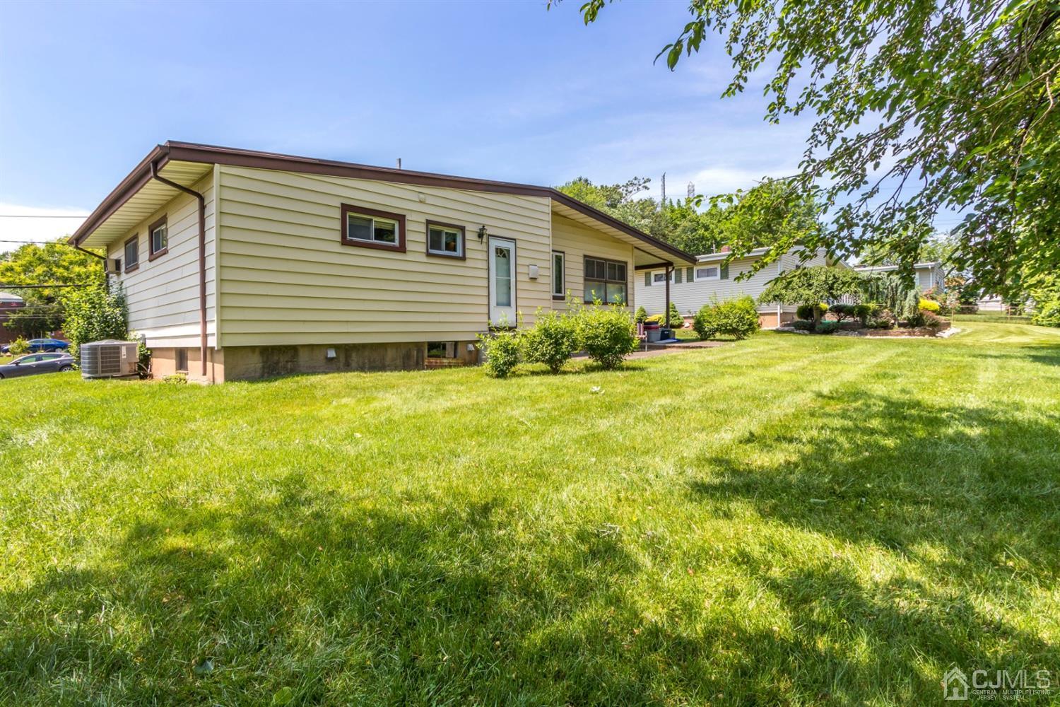 27 Mill Road Edison, NJ 08817 - Photo 26 of 31 a front view of house with yard and trees