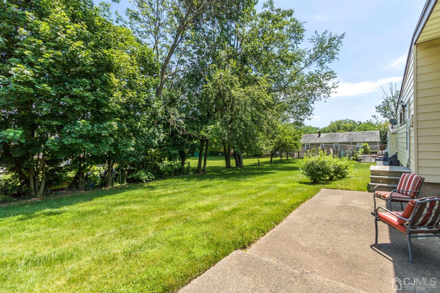 27 Mill Road Edison, NJ 08817 - Photo 28 of 31 a view of a garden with a bench in a garden