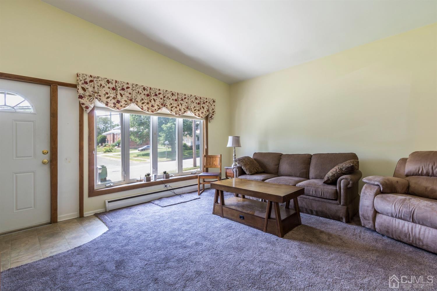 27 Mill Road Edison, NJ 08817 - Photo 4 of 31 a living room with furniture and a large window