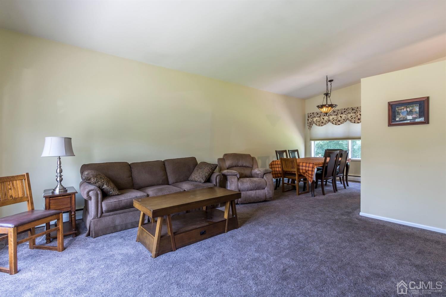 27 Mill Road Edison, NJ 08817 - Photo 6 of 31 a living room with furniture and a lamp