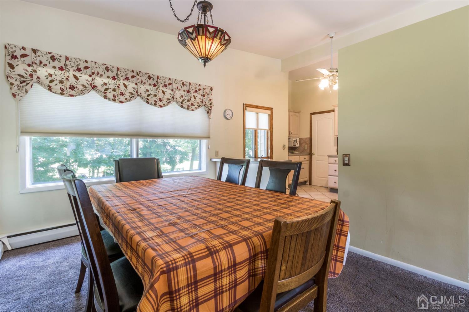 27 Mill Road Edison, NJ 08817 - Photo 9 of 31 a dining room with a wooden table and chairs