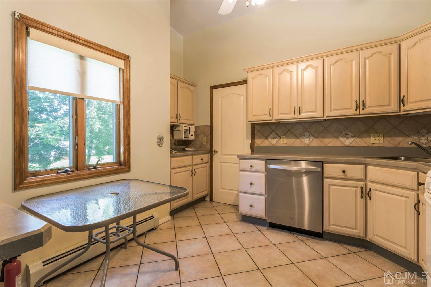 27 Mill Road Edison, NJ 08817 - Photo 10 of 31 a kitchen with stainless steel appliances granite countertop a stove a sink and a refrigerator