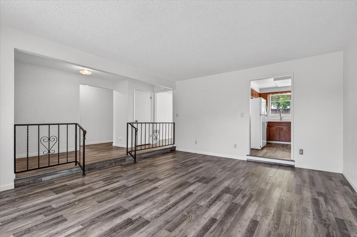 415 Sutter Avenue Medford, OR 97504 - Photo 6 of 28 a view of an empty room with wooden floor and a window
