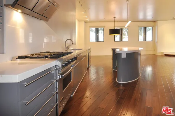 a view of a kitchen with a sink and wooden floor