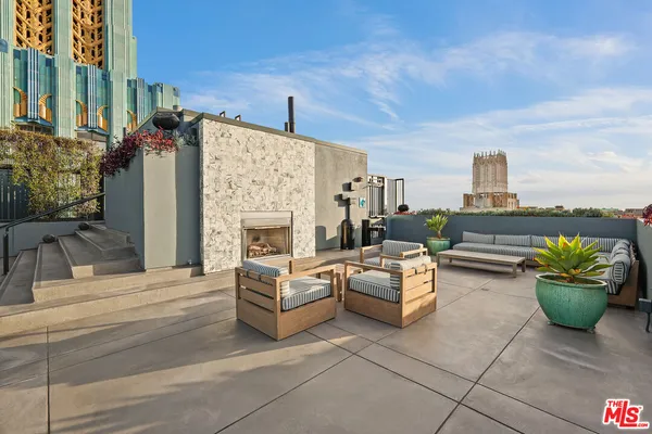 a terrace with outdoor seating and city view