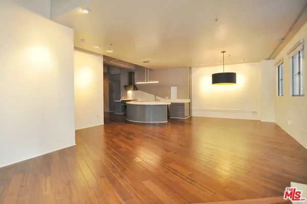 a view of kitchen and hall with wooden floor