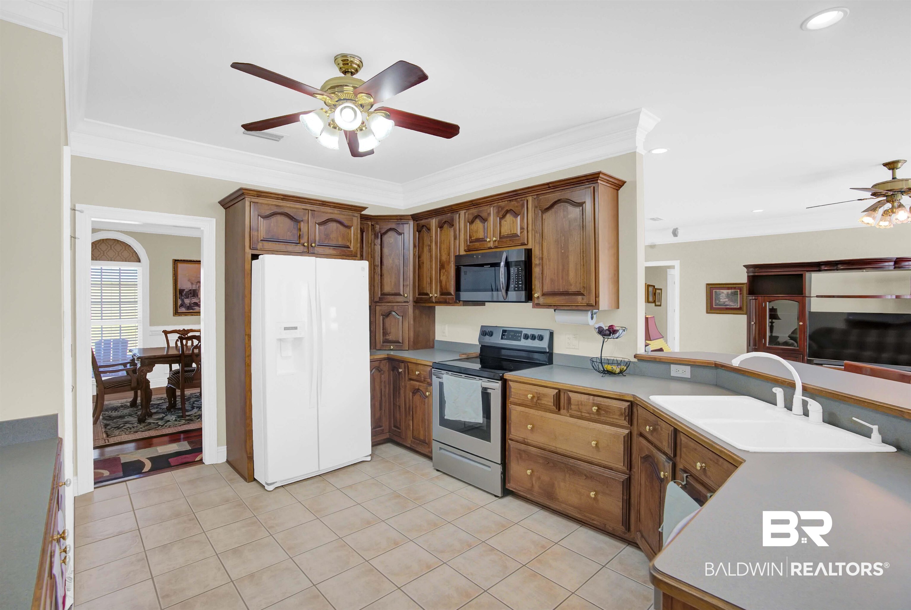 27688 Rigsby Road Daphne, AL 36526 - Photo 17 of 56 Kitchen with appliances with stainless steel finishes, light tile patterned flooring, sink, and ceiling fan
