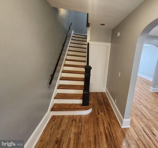 a kitchen with granite countertop a sink stove and cabinets