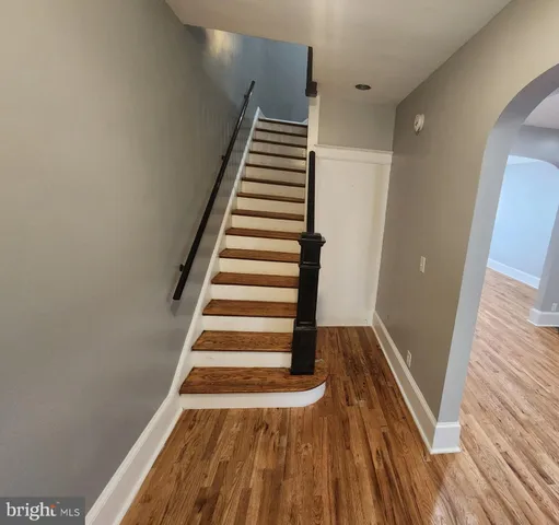 a kitchen with granite countertop a sink stove and cabinets
