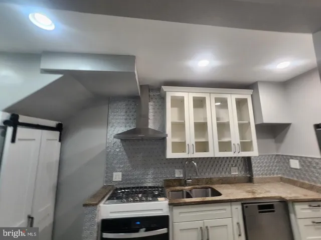 a view of a room with wooden floor and chandelier