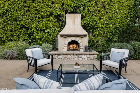 a view of a patio with couches chairs and a potted plant