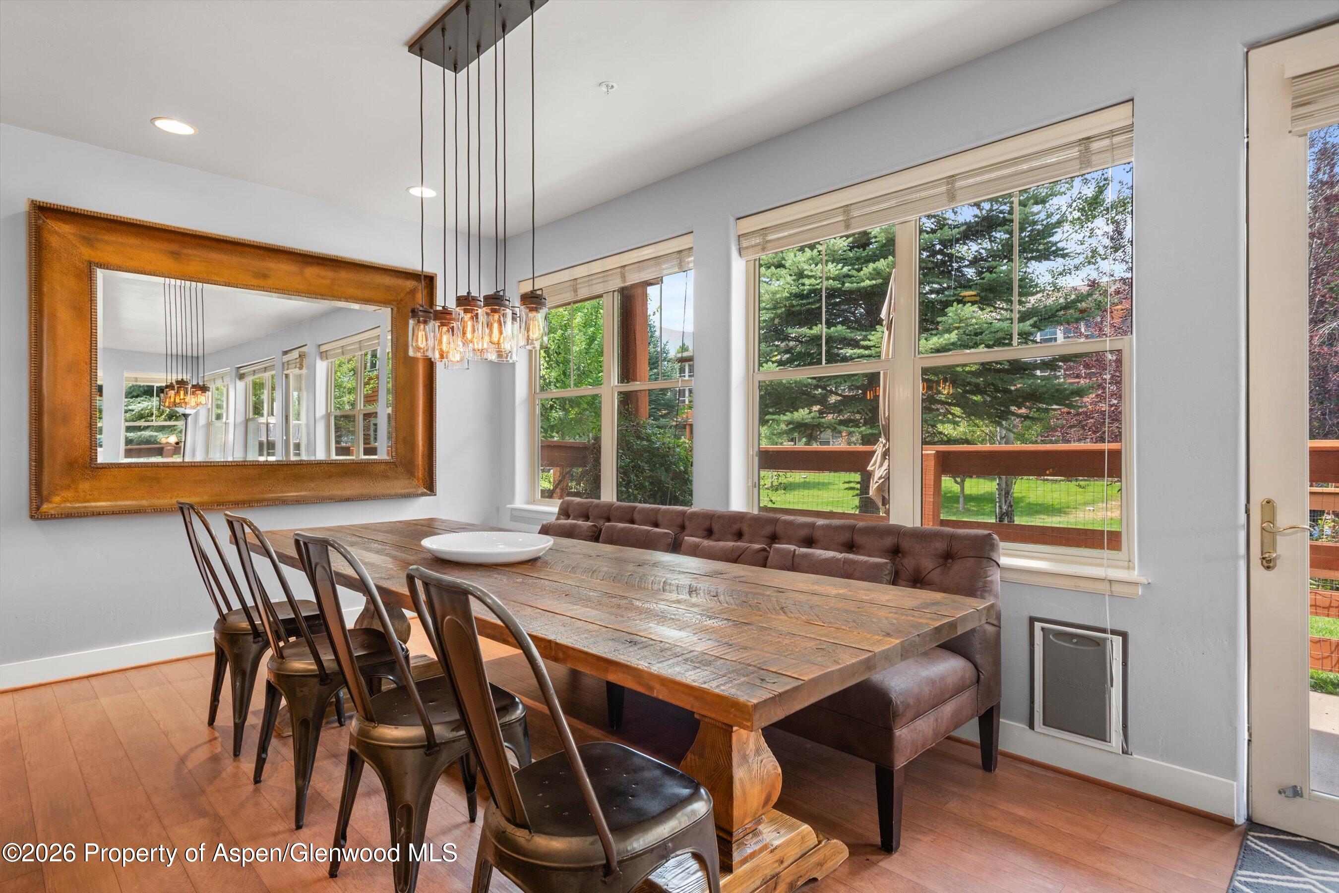 548 Evans Court Basalt, CO 81621 - Photo 13 of 36 a dining room with furniture a chandelier and wooden floor