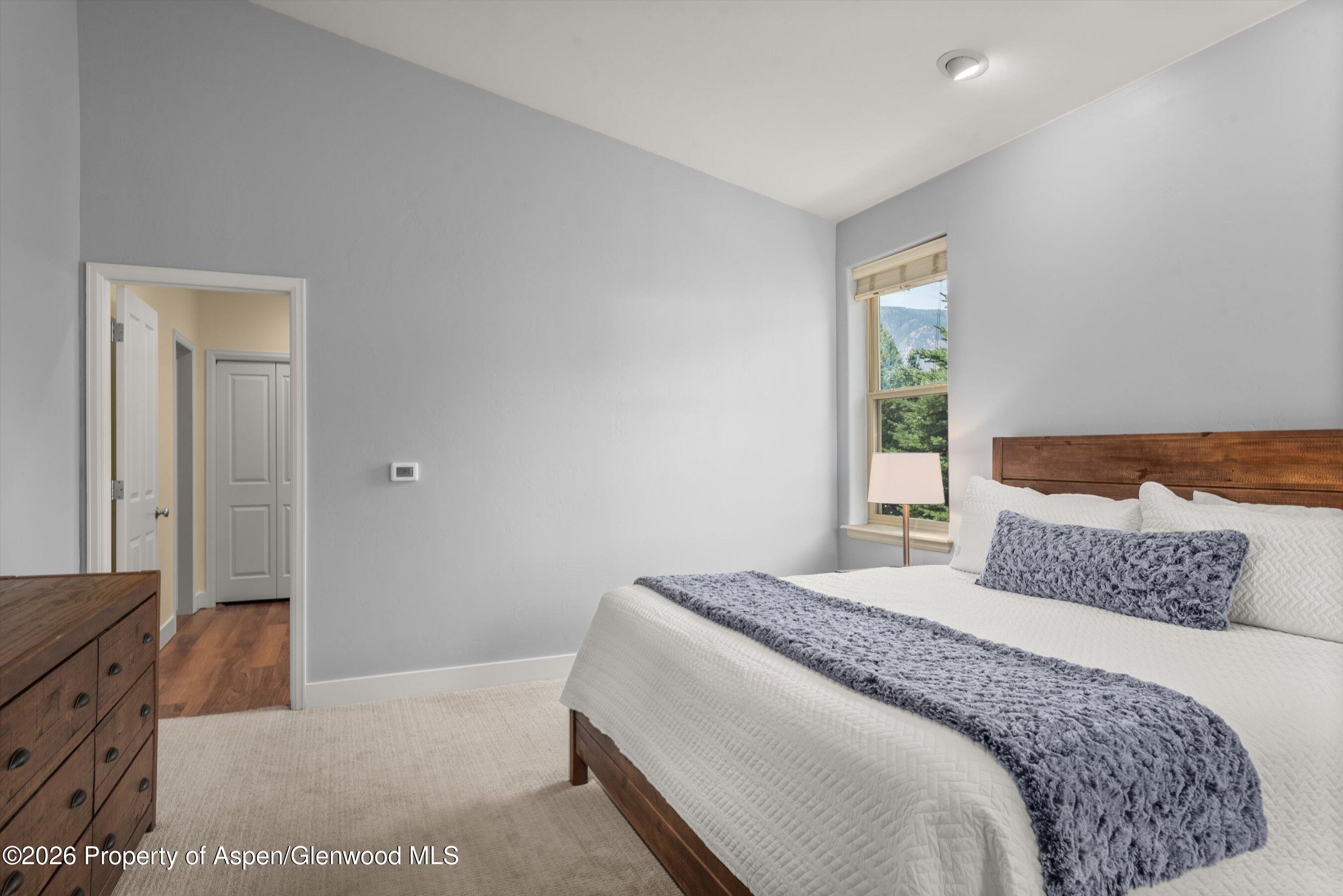 548 Evans Court Basalt, CO 81621 - Photo 25 of 36 a bedroom with a large bed and a dresser