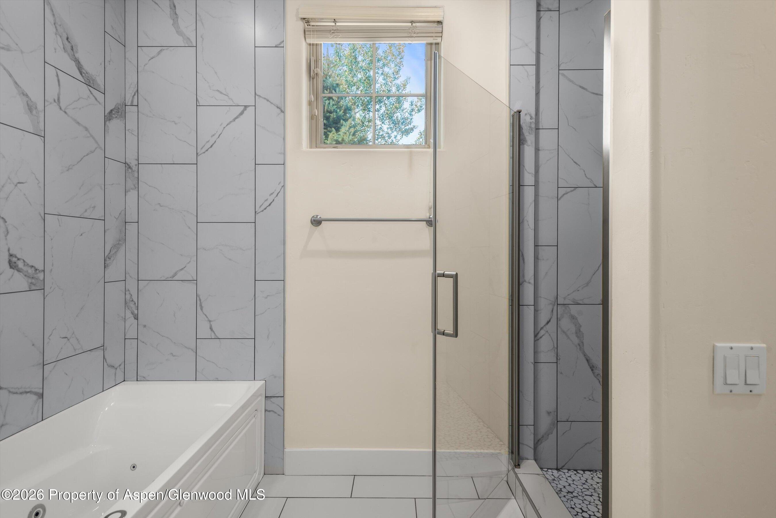 548 Evans Court Basalt, CO 81621 - Photo 28 of 36 a bathroom with a bathtub and shower