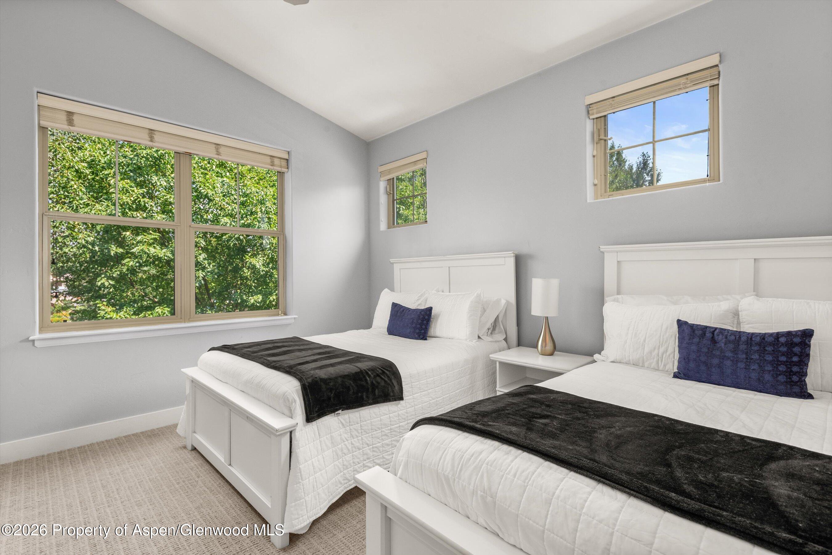 548 Evans Court Basalt, CO 81621 - Photo 30 of 36 a bedroom with two beds and a window