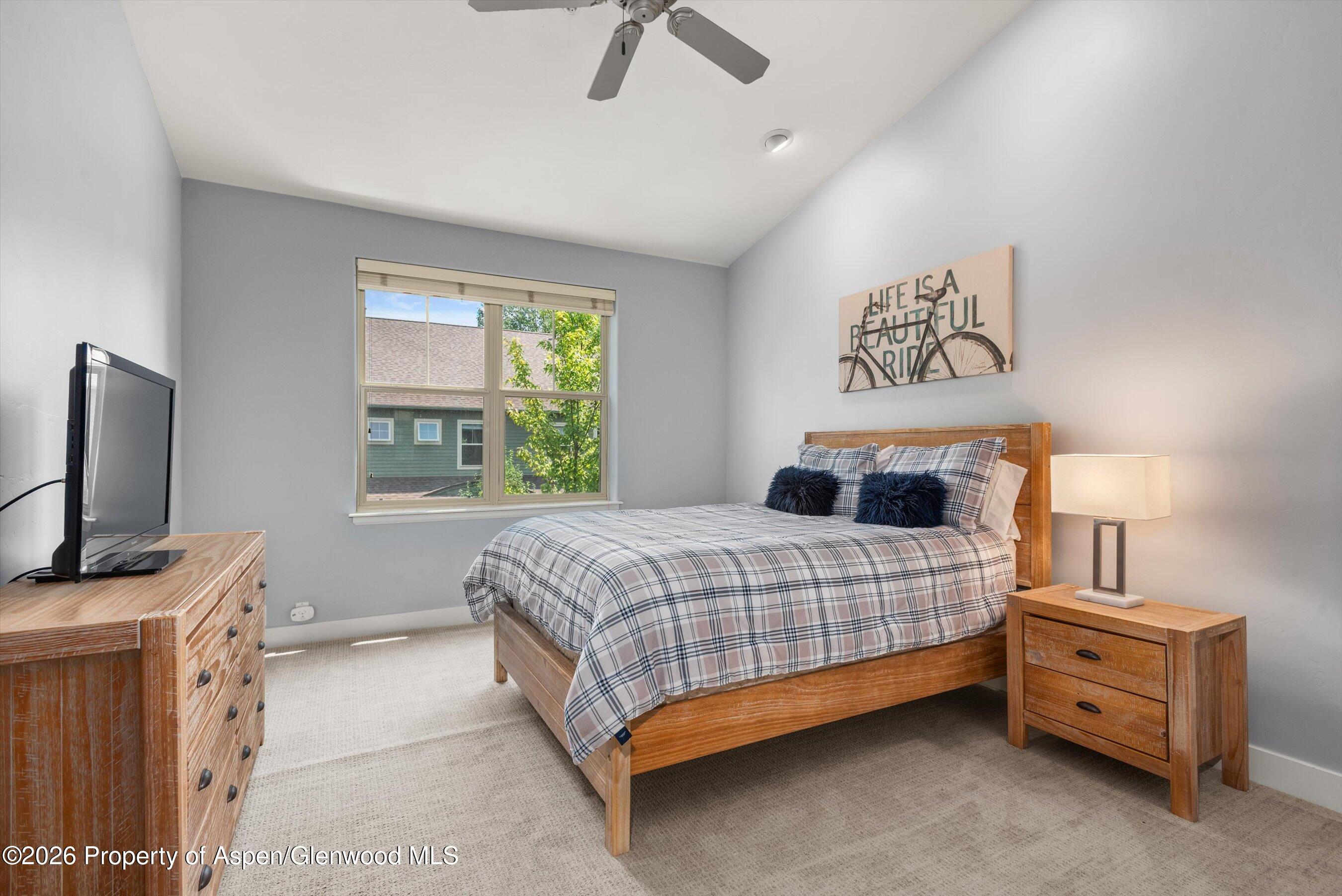 548 Evans Court Basalt, CO 81621 - Photo 33 of 36 a bedroom with a bed and a flat tv screen on dresser