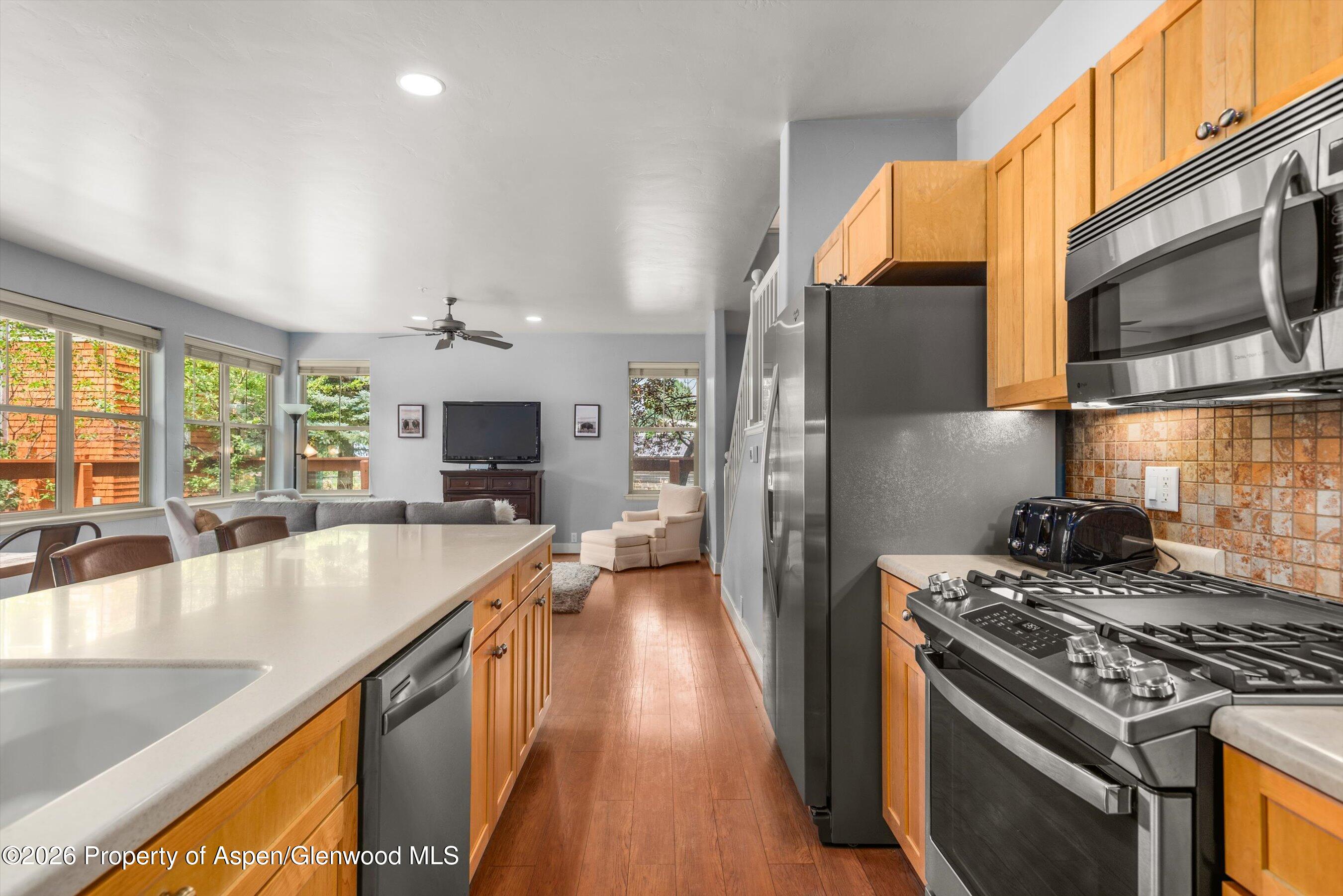 548 Evans Court Basalt, CO 81621 - Photo 5 of 36 a kitchen with stainless steel appliances granite countertop a stove a sink and a microwave