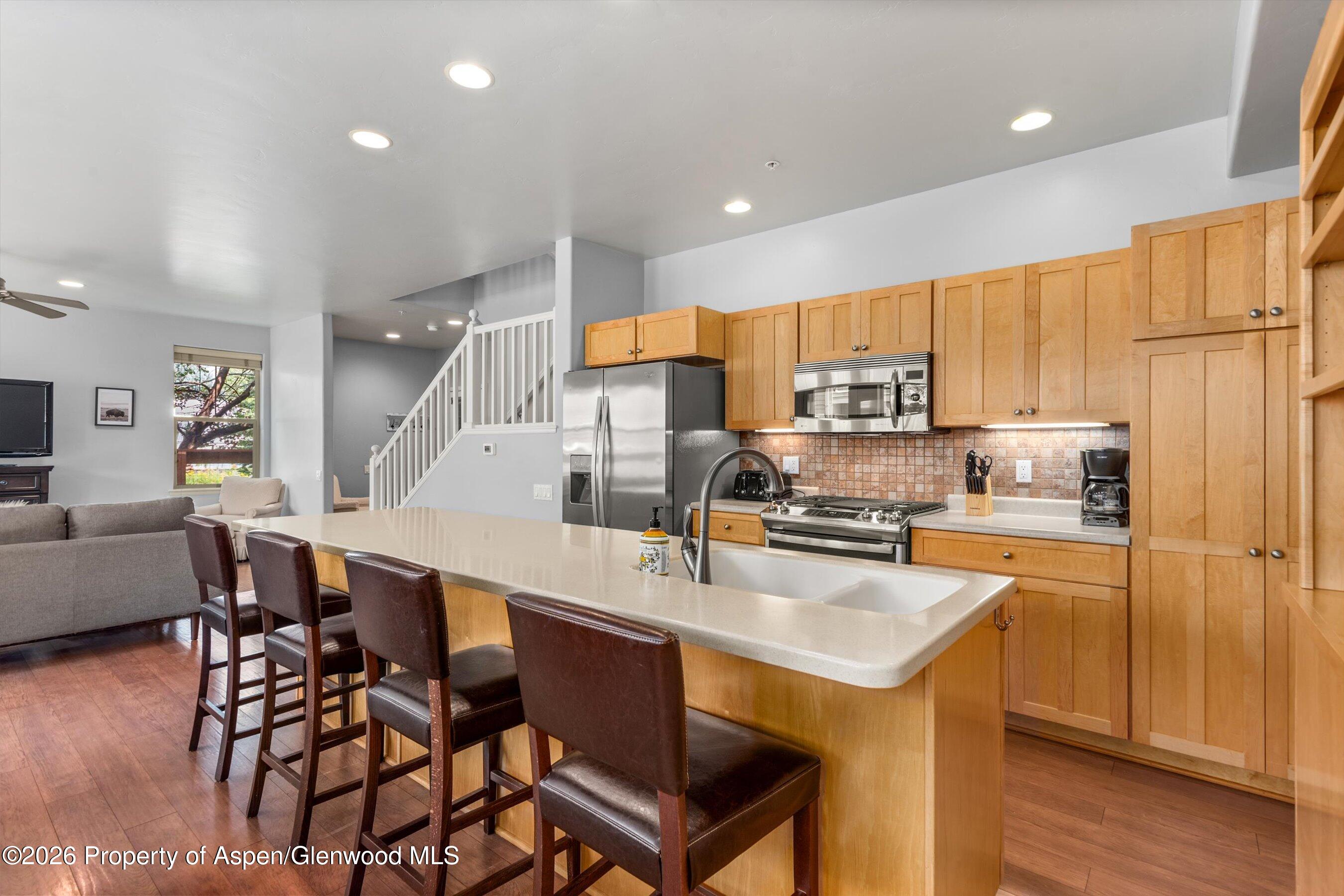 548 Evans Court Basalt, CO 81621 - Photo 7 of 36 a kitchen with a sink a counter top space stainless steel appliances and cabinets