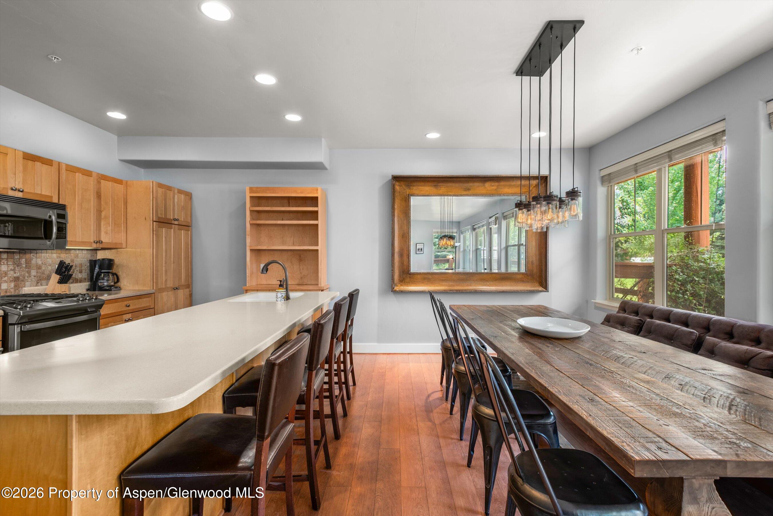 548 Evans Court Basalt, CO 81621 - Photo 9 of 36 a kitchen with stainless steel appliances granite countertop a stove a refrigerator a kitchen island a table and chairs