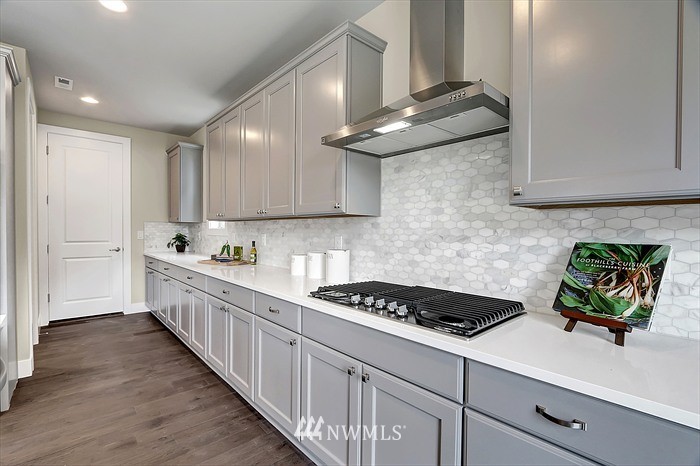 311 Field Place Southeast Renton, WA 98059 - Photo 7 of 8 a kitchen with stainless steel appliances granite countertop a sink stove and cabinets
