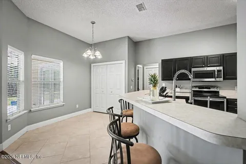 a room with furniture a chandelier and a flat screen tv