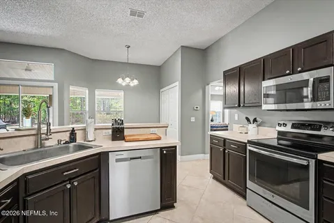 a kitchen with stainless steel appliances stove microwave and sink