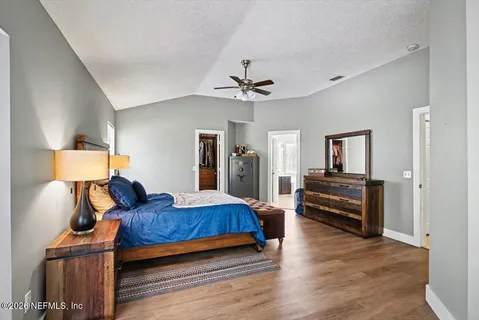 a bedroom with furniture and wooden floor