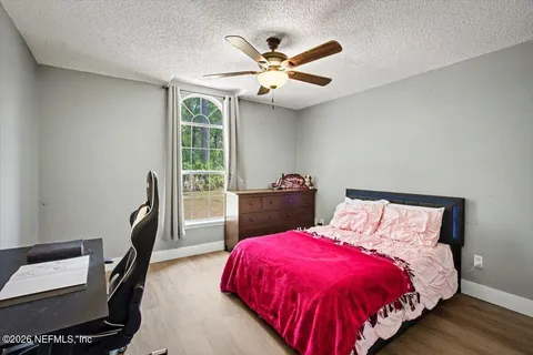 a bed sitting in a bedroom next to a window