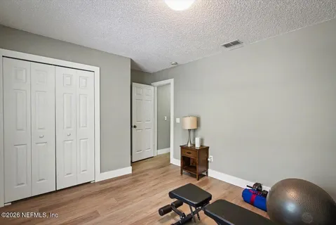 a view of a workspace with furniture and wooden floor