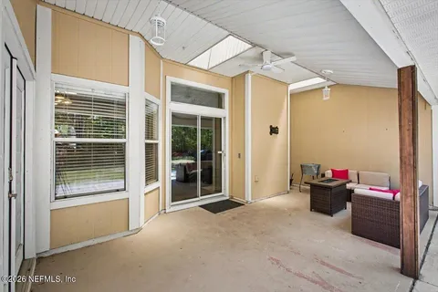 a living room with furniture and a floor to ceiling window