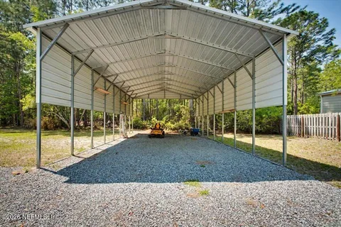 a view of a yard with a tree