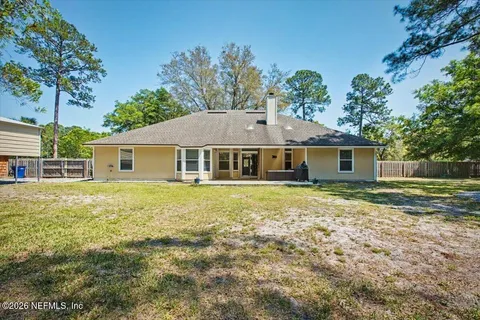 an aerial view of a house with a yard and garden