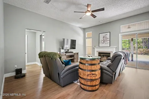 a living room with furniture ceiling fan and a window