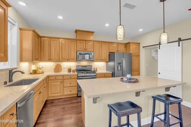 a kitchen with stainless steel appliances a sink stove and refrigerator