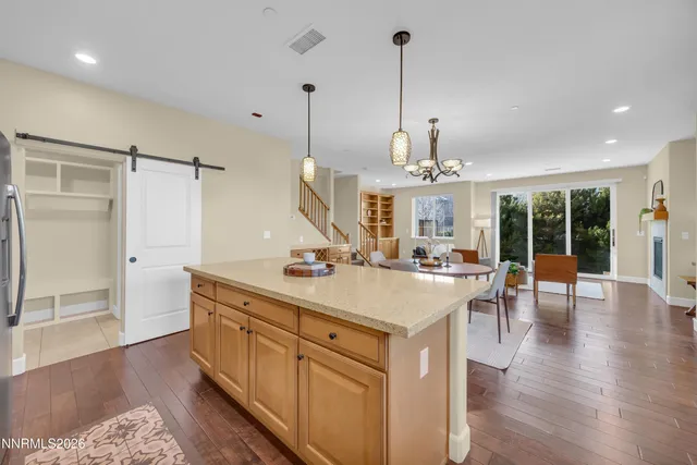 a kitchen with a sink a counter top space and stainless steel appliances