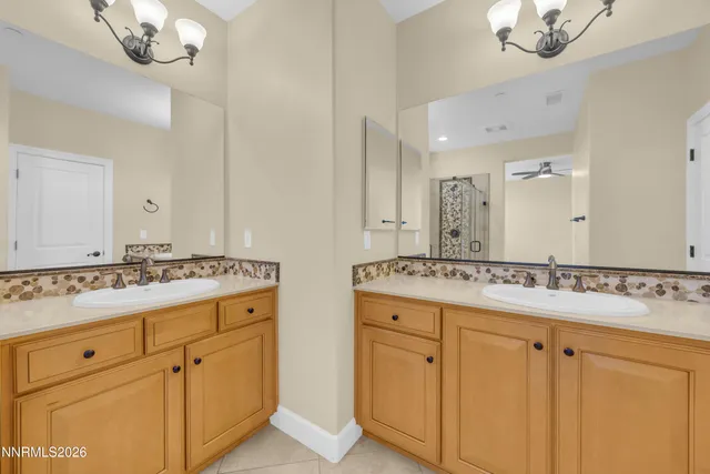 a bathroom with a sink vanity granite and a mirror