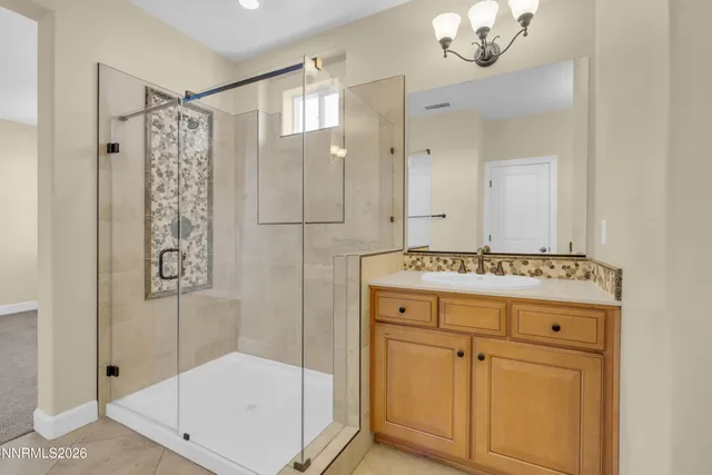 a bathroom with a shower sink and mirror