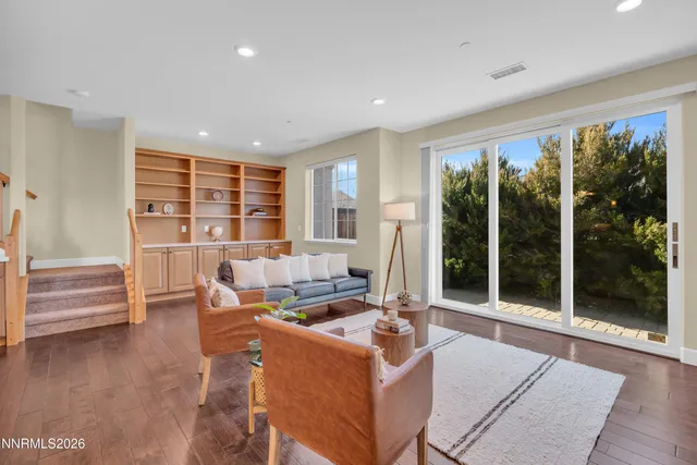 a living room with furniture and large windows