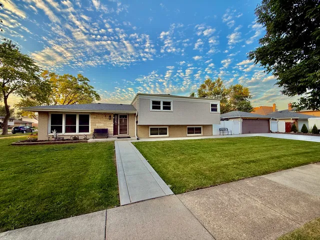 a front view of a house with a garden