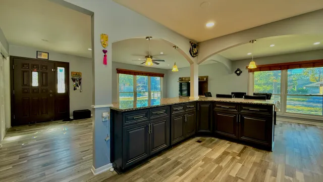 a kitchen with a sink cabinets and wooden floor