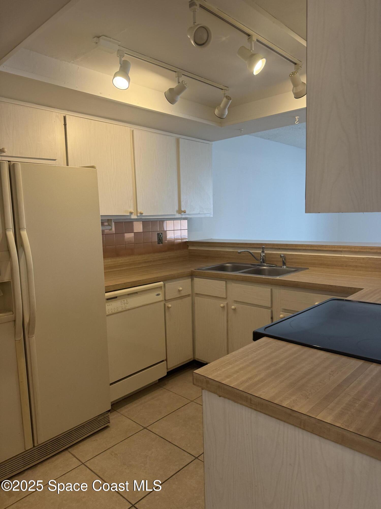 212 Augusta Way Melbourne, FL 32940 - Photo 22 of 49 a kitchen with a sink appliances and cabinets