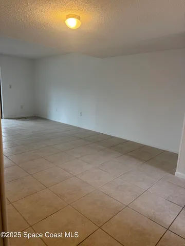 a kitchen with granite countertop white cabinets stainless steel appliances a sink and a window