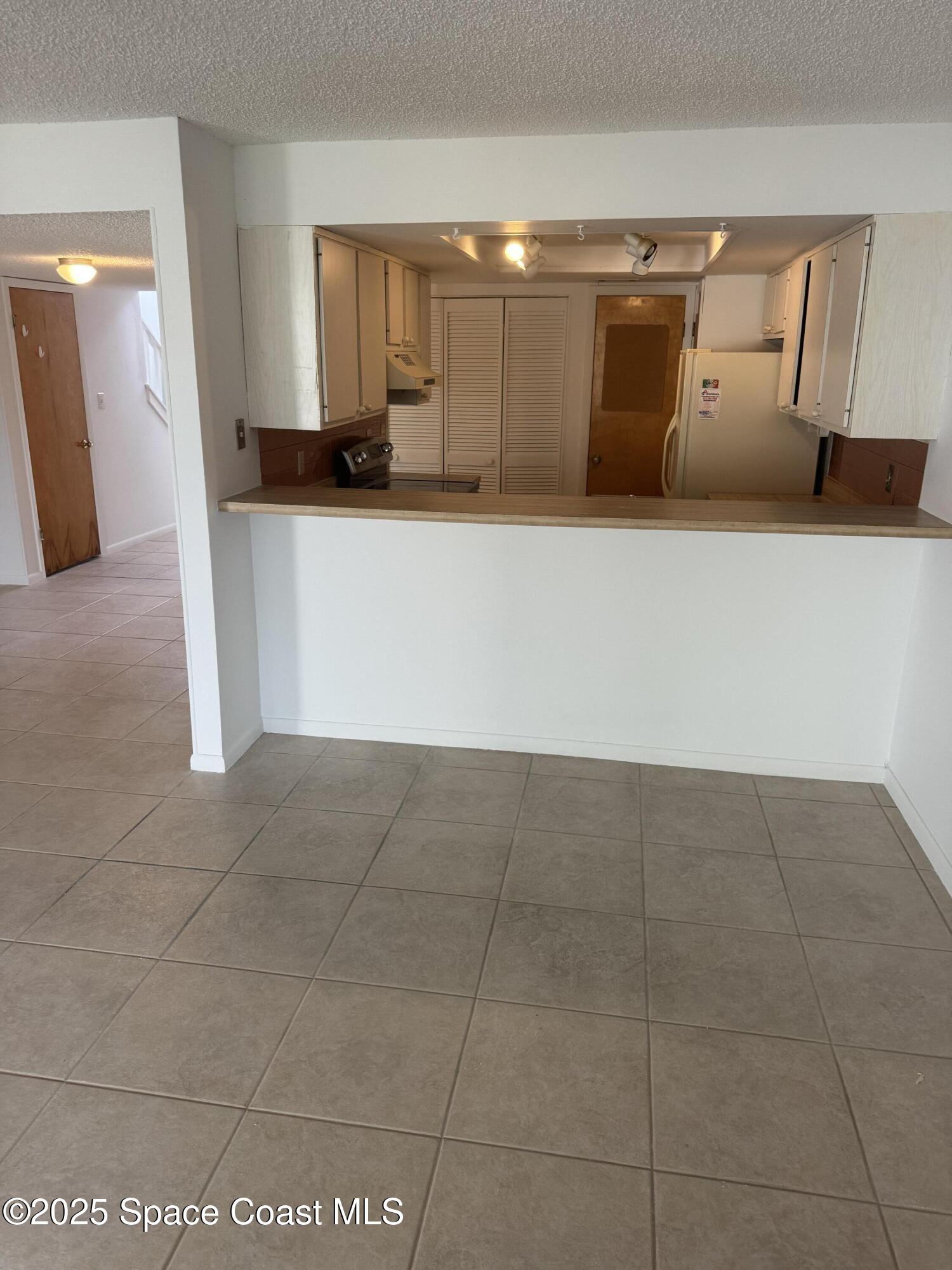 212 Augusta Way Melbourne, FL 32940 - Photo 30 of 49 a kitchen with granite countertop a sink and cabinets