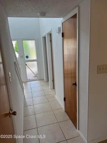 an empty room with windows and cabinet