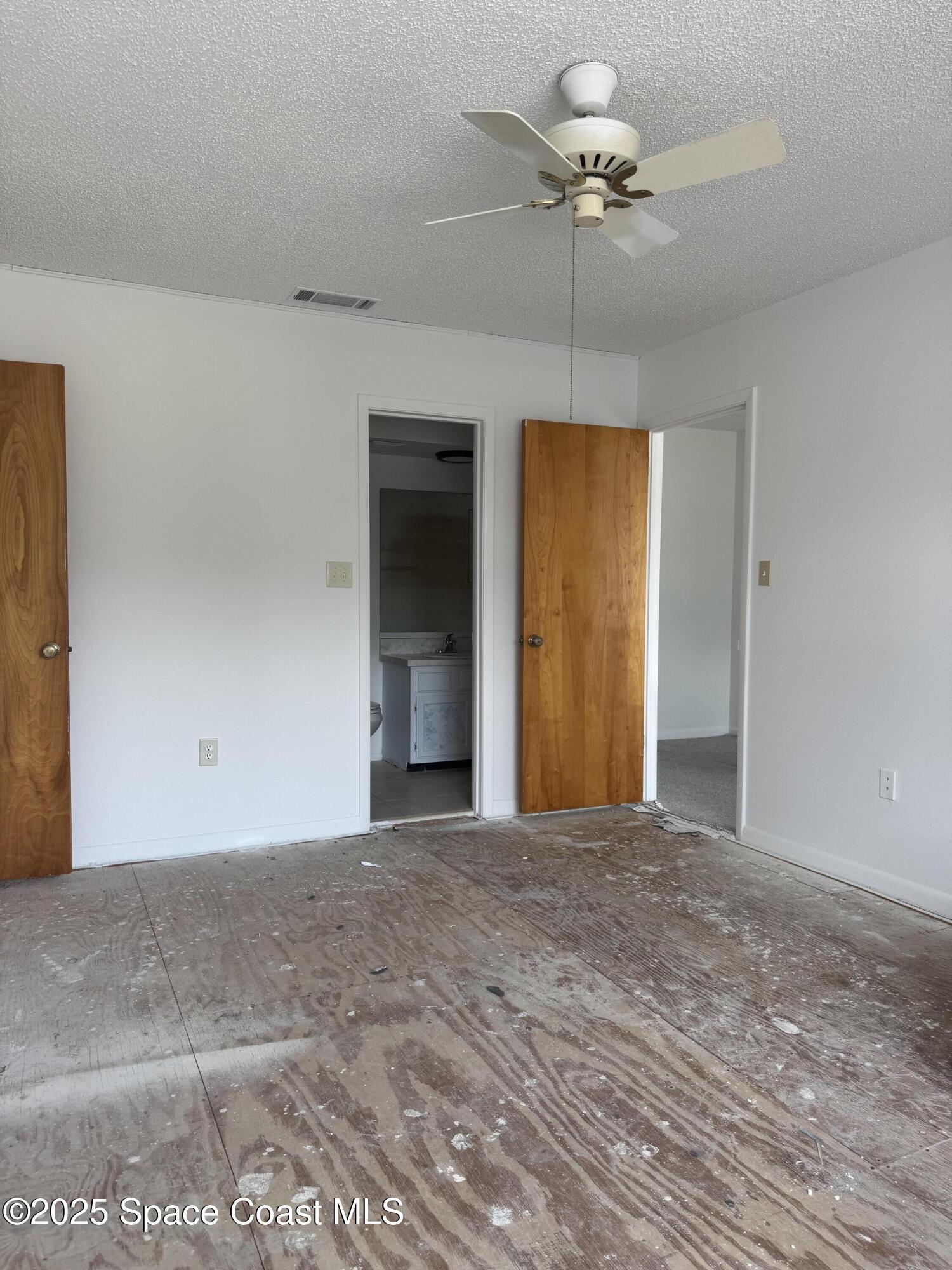 212 Augusta Way Melbourne, FL 32940 - Photo 43 of 49 a view of a room with a ceiling fan and a window