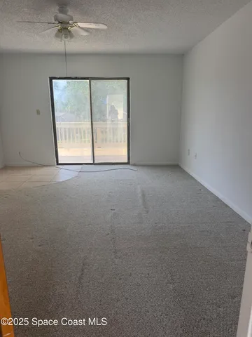 a spacious bathroom with a granite countertop sink and a mirror
