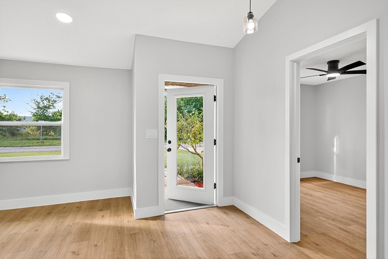 117 High Court Sebastian, FL 32958 - Photo 12 of 54 a view of an empty room with wooden floor and a window