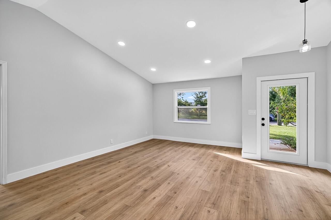 117 High Court Sebastian, FL 32958 - Photo 13 of 54 an empty room with wooden floor and windows