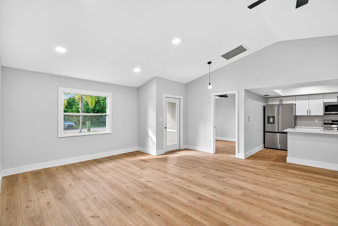 117 High Court Sebastian, FL 32958 - Photo 14 of 54 a view of empty room with wooden floor and window